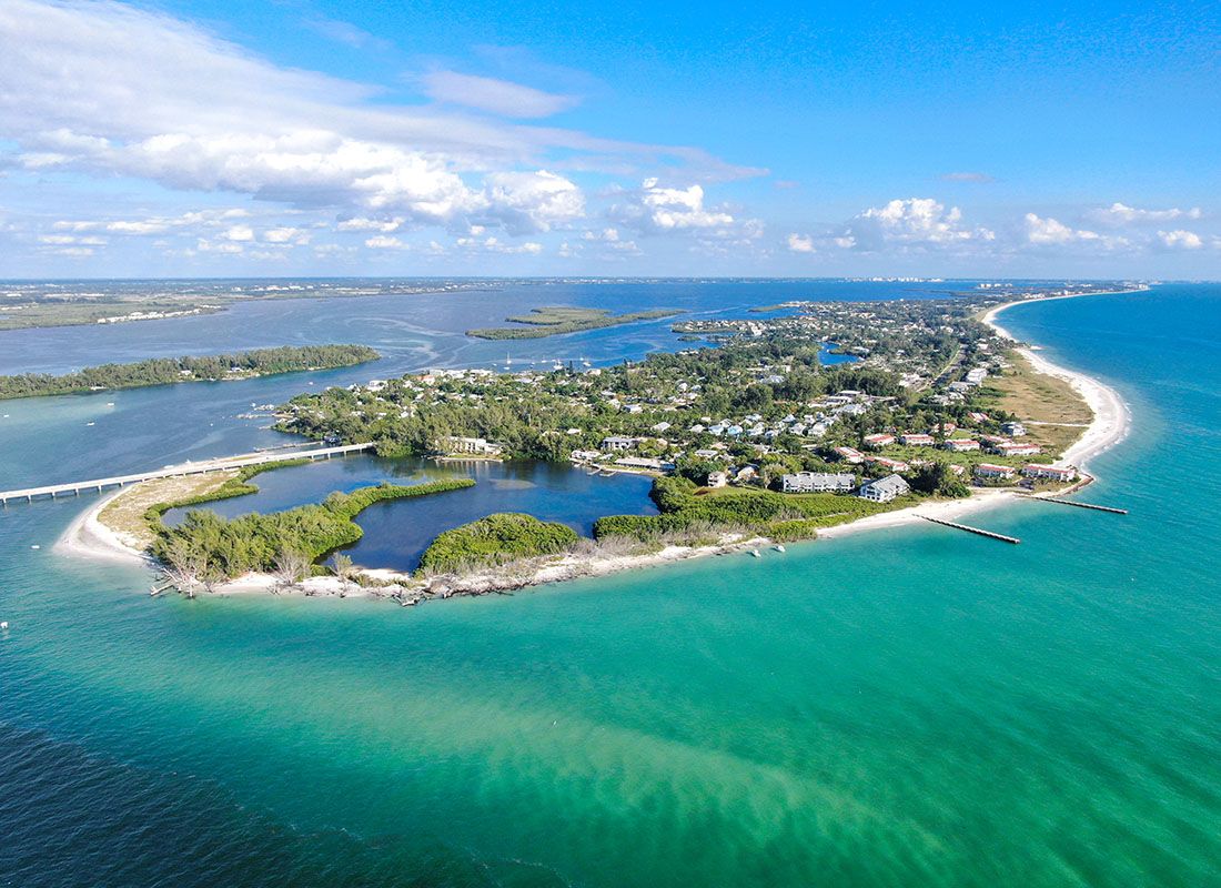Longboat Key, FL - Aerial View of a Small Island with Homes Surrounded by Turquoise Water in Longboat Key Florida
